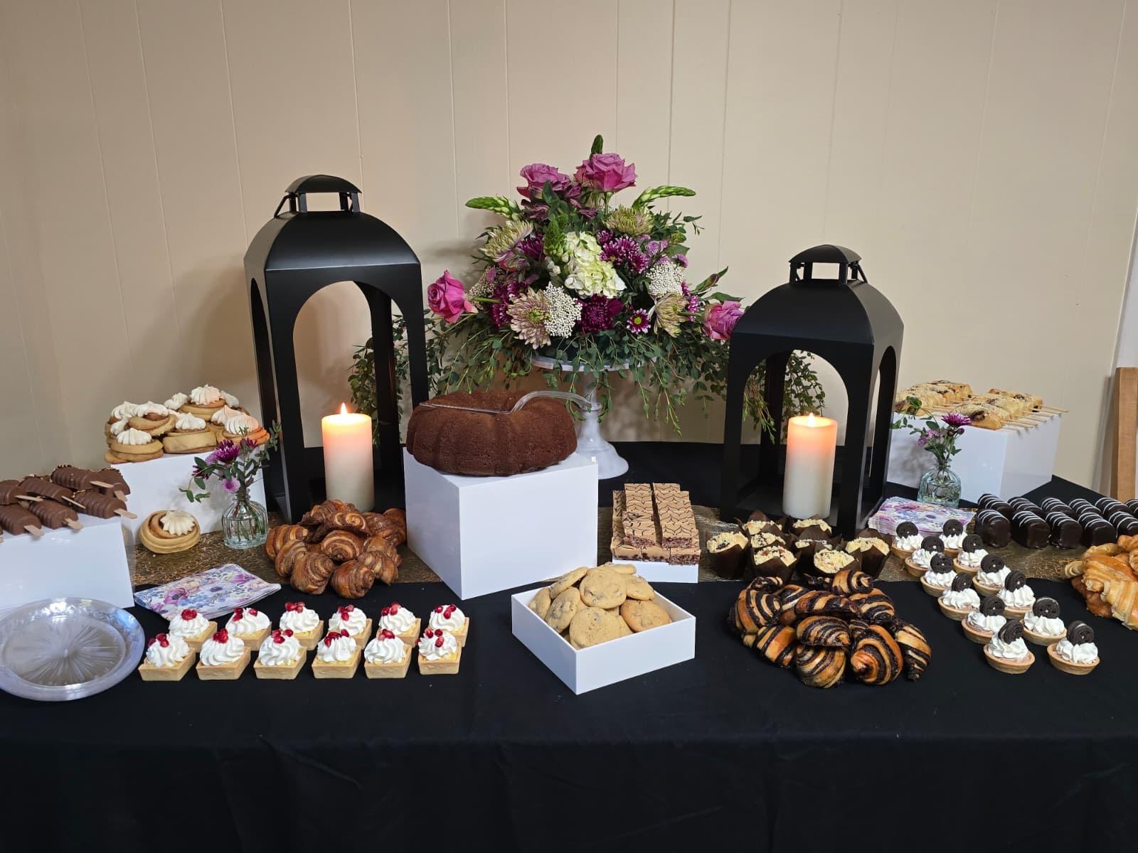 Dessert table with black lanterns and florals